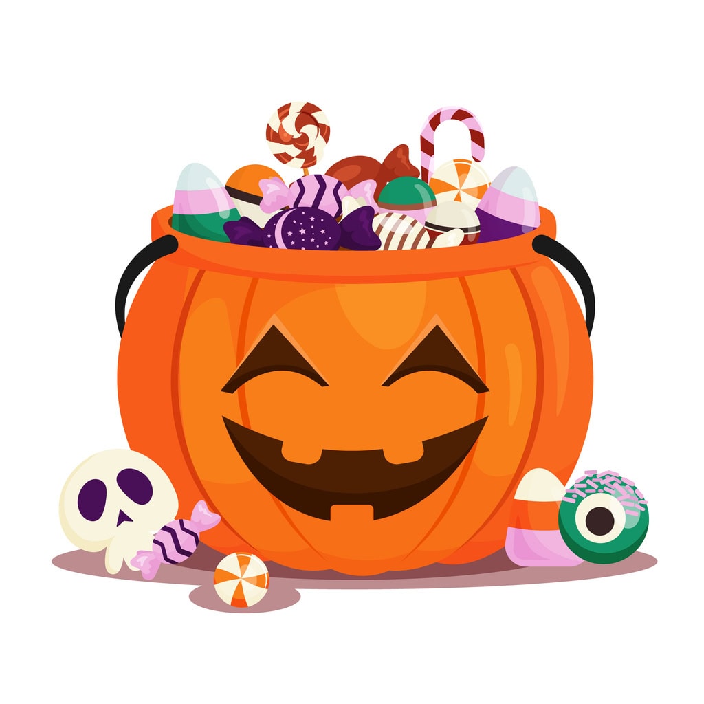 Halloween pumpkin bucket filled with candies and treats for trick or treating.